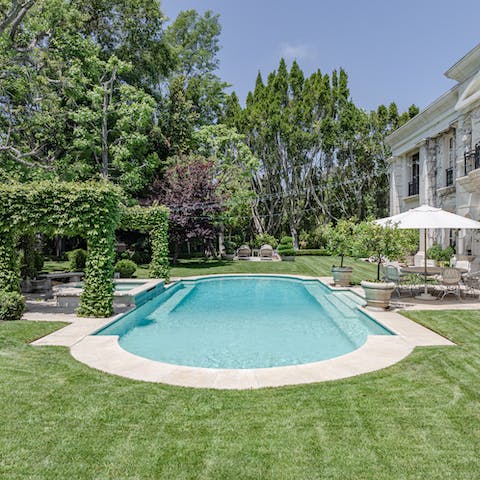 Escape the summer heat with a dip in the stylish stone swimming pool 