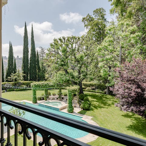 Enjoy the views of the luscious gardens and cypress trees from your balcony
