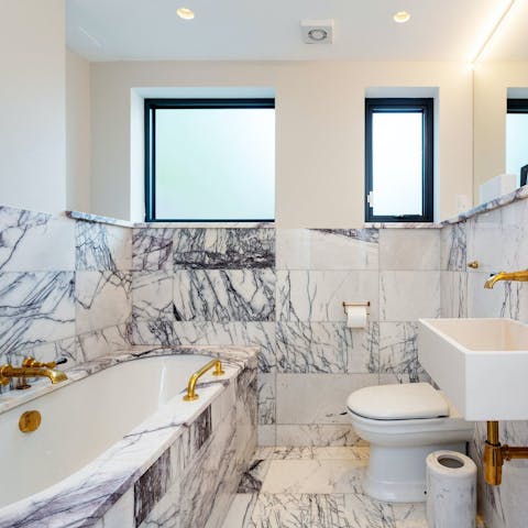 Prepare to relax in the marbled bathroom after an excursion