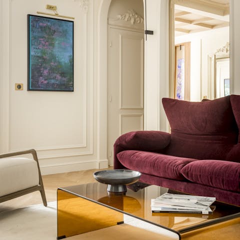 Make yourself comfy on the burgundy sofa