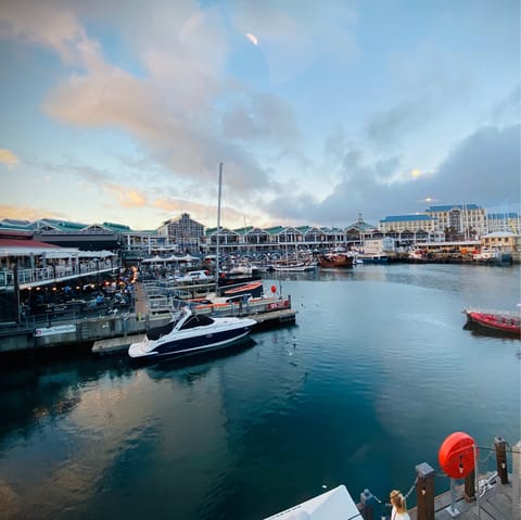 Visit the pretty V&A Waterfront, lined with colourful boats and leading to a huge shopping centre
