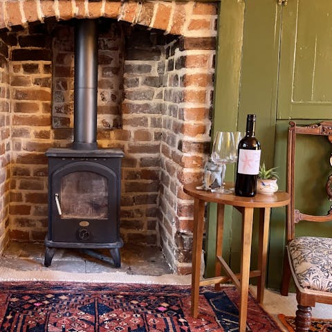 Share a bottle of wine while keeping things cosy by the wood burner