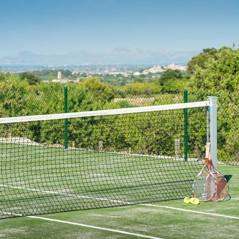 Enjoy a few games of tennis while enjoying great views on the shared tennis court