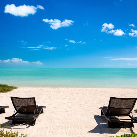 Follow the path straight to the bone-white sand of Long Beach in front of this home