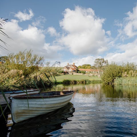 Take turns rowing on the farm's reed-lined lake 