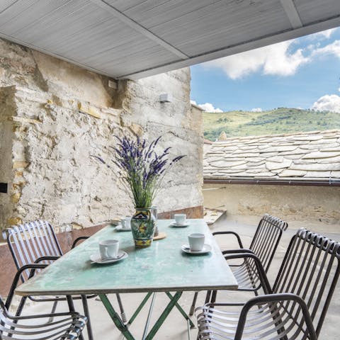 Eat outdoors on your covered roof terrace, with mountain views