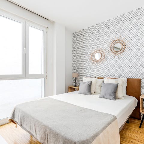 Wake up and open the blinds to let the light flood through the large windows
