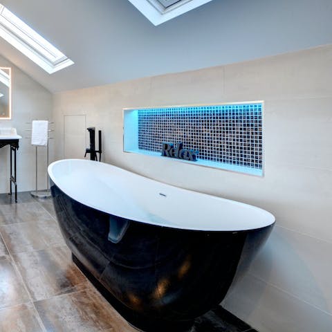 Relax in the luxe tub, complete with mood lighting