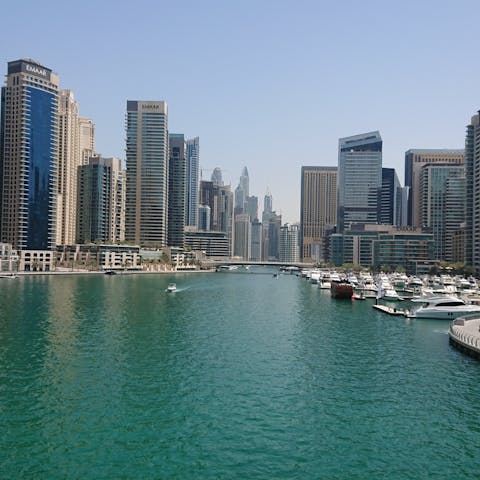 Explore Dubai Marina's scenic promenade and waterfront shops, reachable by car