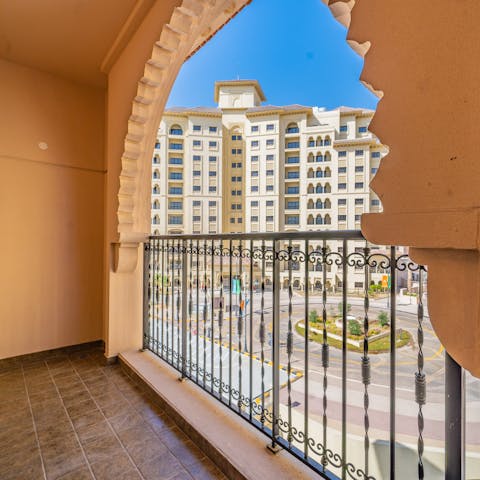 Sip your morning coffee on the private arched balcony ahead of a day of fun and activities