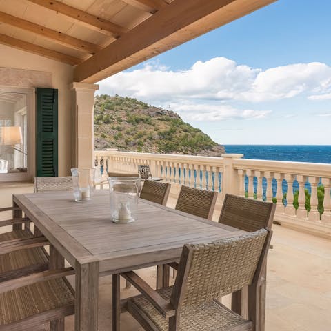Gather on the covered terrace and enjoy the stunning sea views