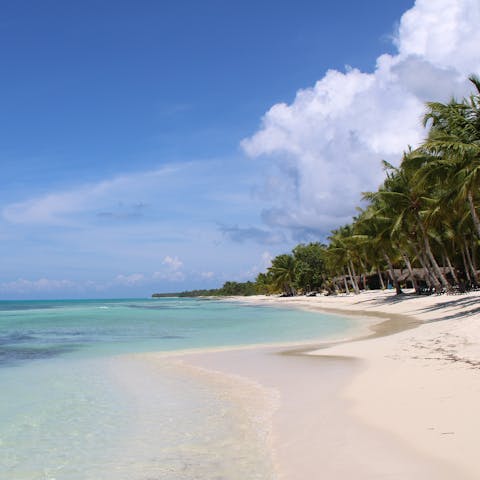 Try your hand at windsurfing in the crystal-clear waters