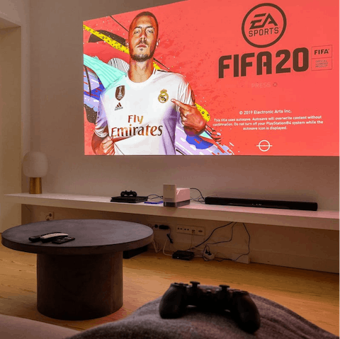 Switch on the projector and challenge your loved ones to a game of Fifa or settle in with a movie
