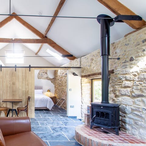 Cosy up between the original stone walls and wood-burning stove