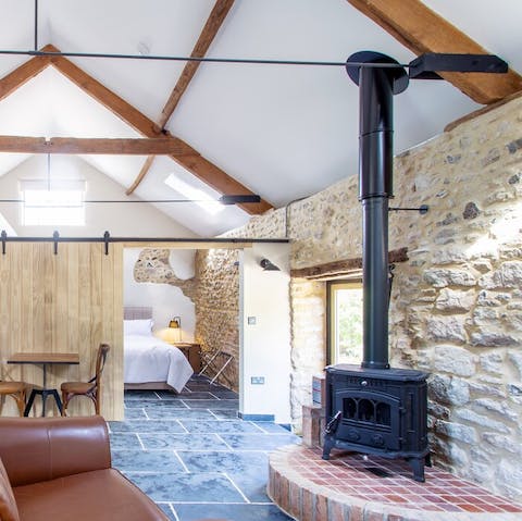 Cosy up between the original stone walls and wood-burning stove