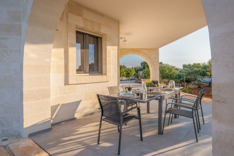 Dine alfresco on the panoramic terrace, eating pizza and sipping wine with loved ones