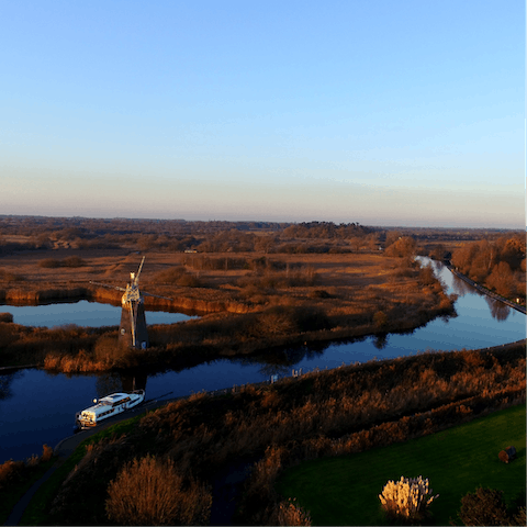 Explore the nearby Norfolk Broads by boat