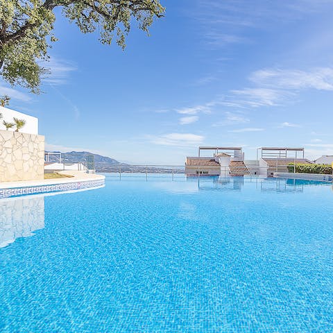 While away sunny hours in the communal pool framed by glorious mountain views