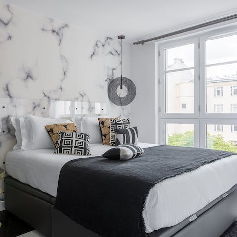 Fall asleep in the elegant marble-clad master bedroom