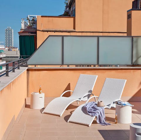 Sunbathe on the communal rooftop terrace 