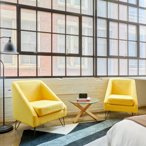 Enjoy a quiet read sunken into one of the mellow yellow upholsteries  