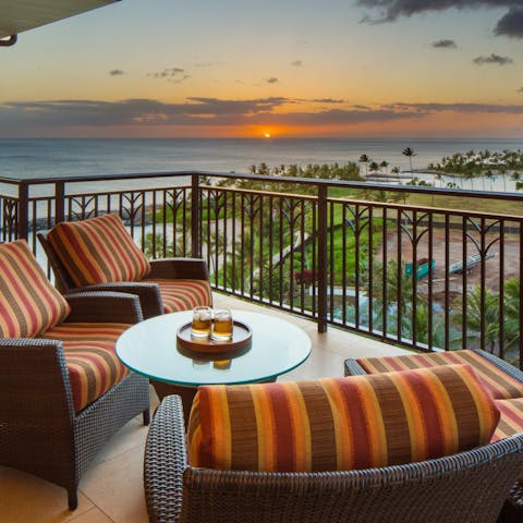 Watch the sunset over the ocean from the private balcony