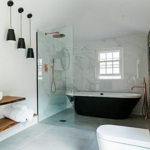 Take a well-earned soak in the elegant black-surround bathtub