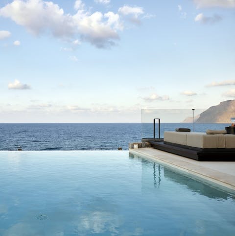 Swim to the edge of the private pool and soak up the sparkling sea views before you