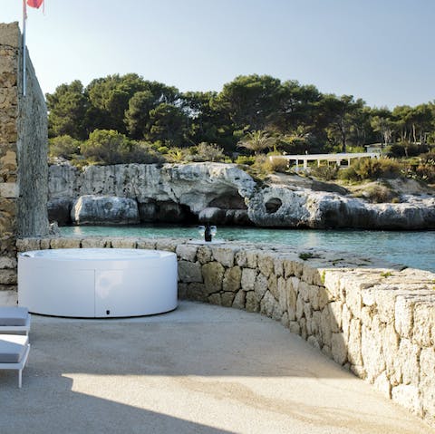 Slip into the bubbling hot tub and gaze out over the ocean