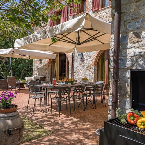 Dine alfresco on the sun-dappled patio, equipped with a barbecue grill