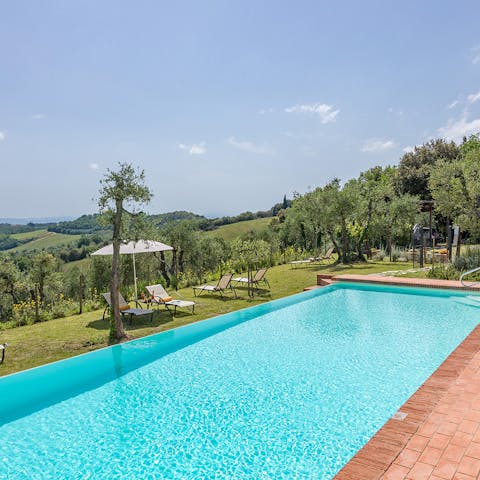 Take a refreshing dip in the pool overlooking the Tuscan hills