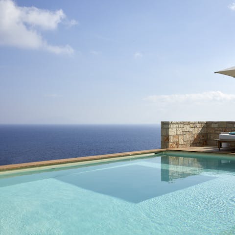 Gaze out at the Aegean Sea from the cool of your private infinity pool