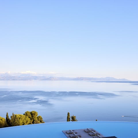 Enjoy the incredible view of hazy blue sea and the mainland tinged pink at the shared pool