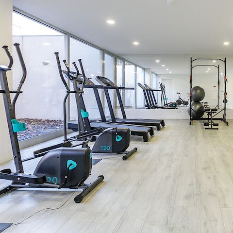 Stay on top of your fitness goals with a workout in the well-equipped communal gym