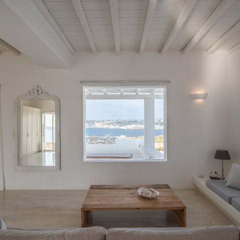 Drink in the beautiful views of Delos Island and Mykonos Town