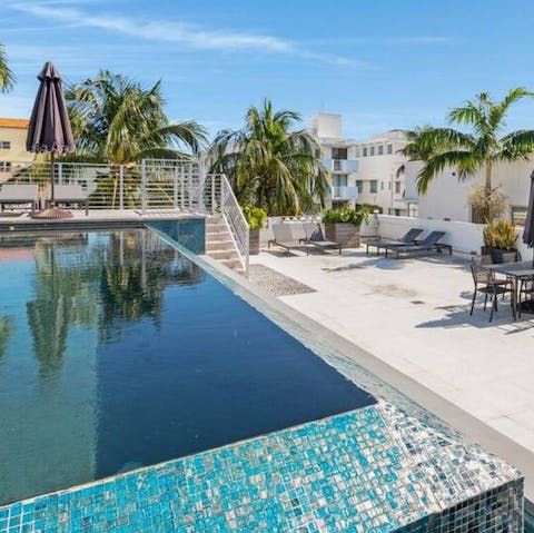 Float away under blue skies in the private infinity pool