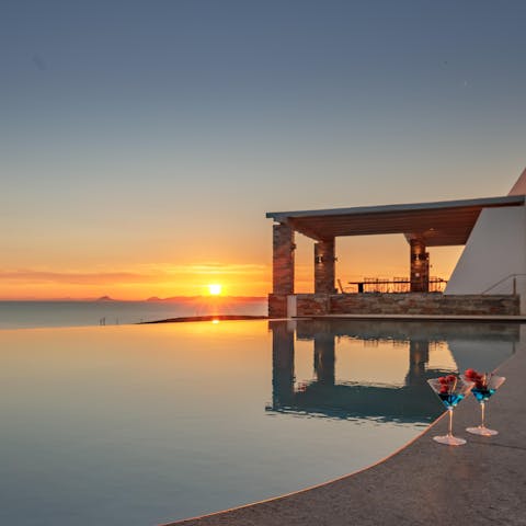 Watch the sun dip below the sea from the cool waters of your infinity pool