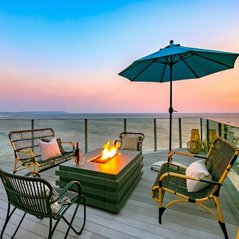 Experience magical sunsets on the ocean-front deck