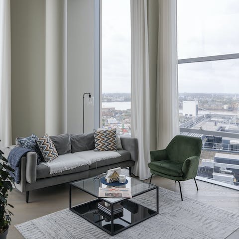 Relax on the comfy sofa with its throws after exploring the Greenwich Peninsula