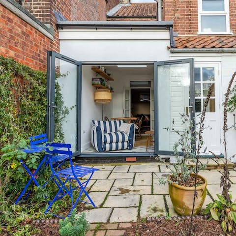 Enjoy a glass of wine in the courtyard garden with its snazzy blue chairs