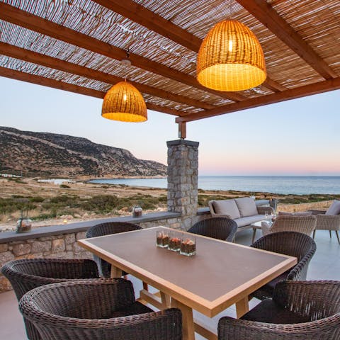 Spend balmy evenings gathered under the dining pergola