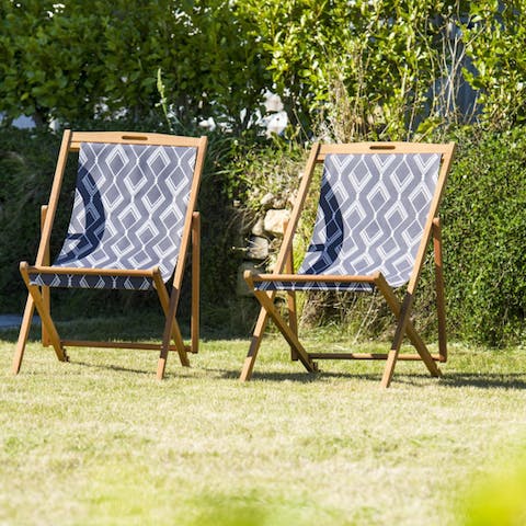 Sun yourself on the deck chairs in the garden