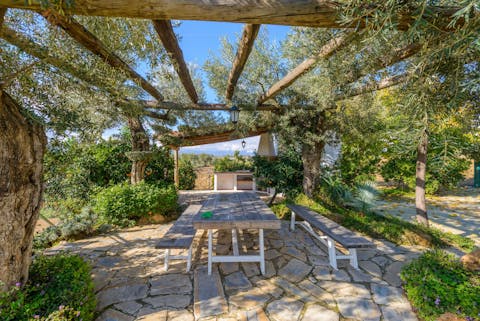 Enjoy a long and leisurely lunch on the leafy pergola in the garden