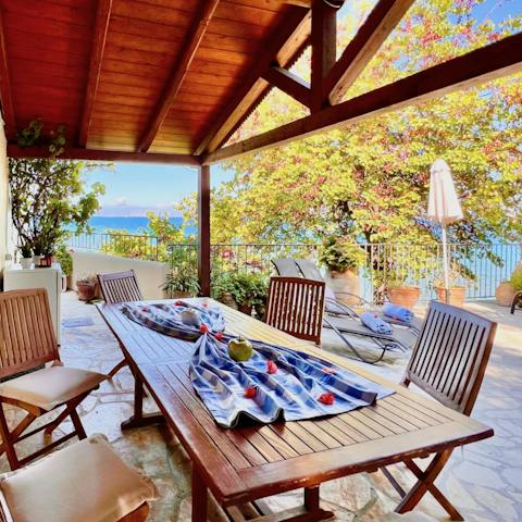 Gather around the outdoor dining table for family lunches of Greek salads and bread
