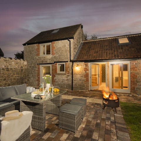 Enjoy long summer evenings dining outside the garden by the warmth of the fire pit