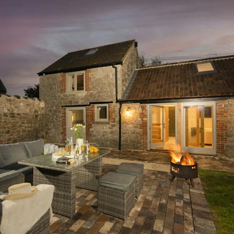 Enjoy long summer evenings dining outside the garden by the warmth of the fire pit