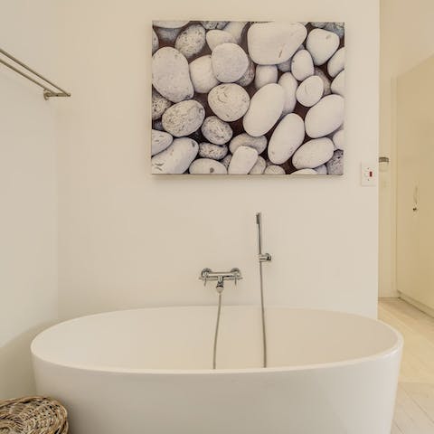 Enjoy a relaxing bubble bath in the free-standing tub