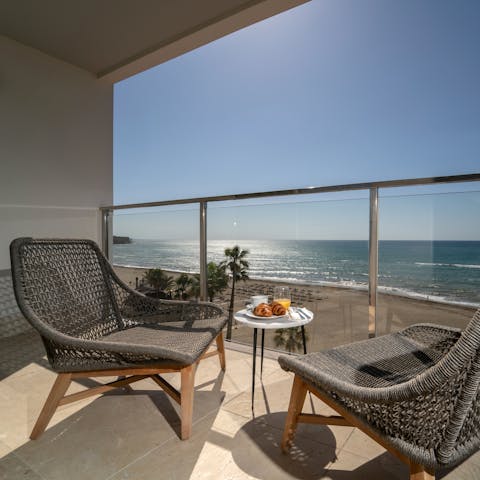 Admire Mediterranean Sea views from the balcony before going for a swim