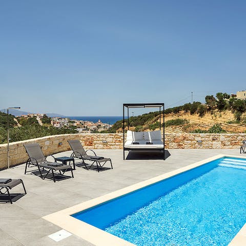Soak up the sun and relax by the luxurious pool with stunning sea views