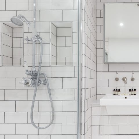 Start mornings with a luxurious soak under the sparkling bathroom's rainfall shower